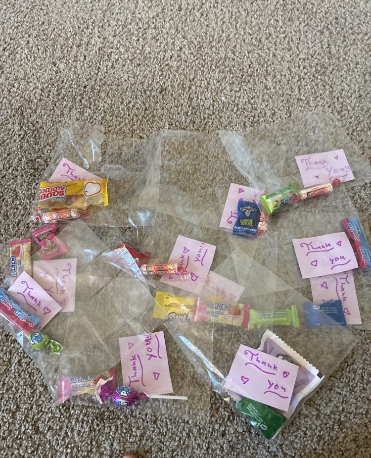 Little clear treat bags filled with candy, each with a handwritten thank-you note