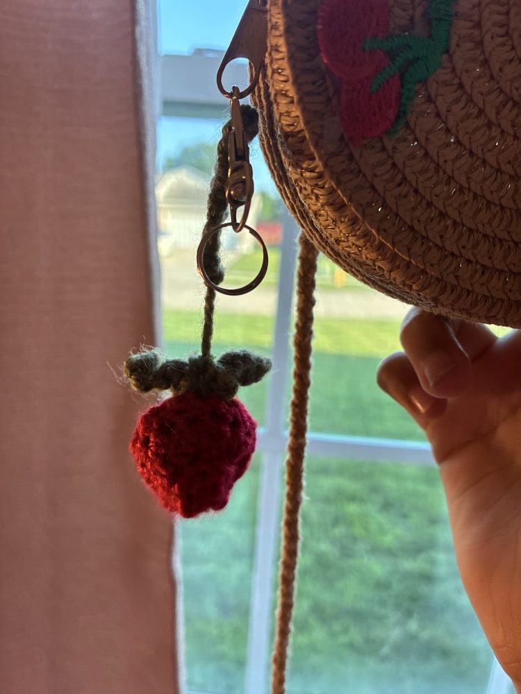 Little red crochet strawberry charm on a keyring