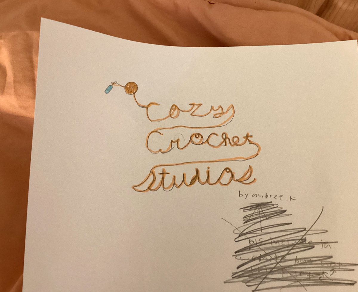 Aubree's original hand-drawn sketch of the Cozy Crochet Studio logo in orange marker